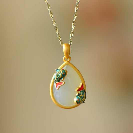 Close-up of lotus and fish design Hetian jade pendant with colorful enamel in vintage silver