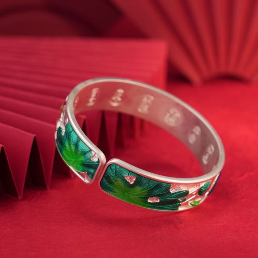 Close-up of colored enamel Pisces pattern on sterling silver bracelet