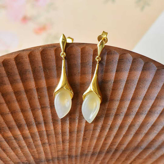 Close-up of smooth nephrite rose design in traditional silver craftsmanship setting