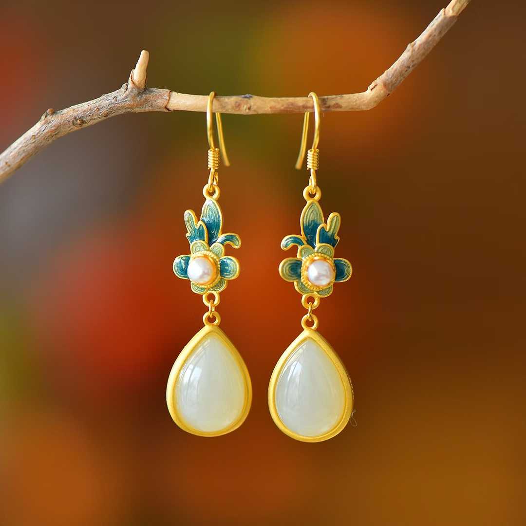 Detailed view of elegant orchid design with teardrop-shaped Hetian jade on antique silver