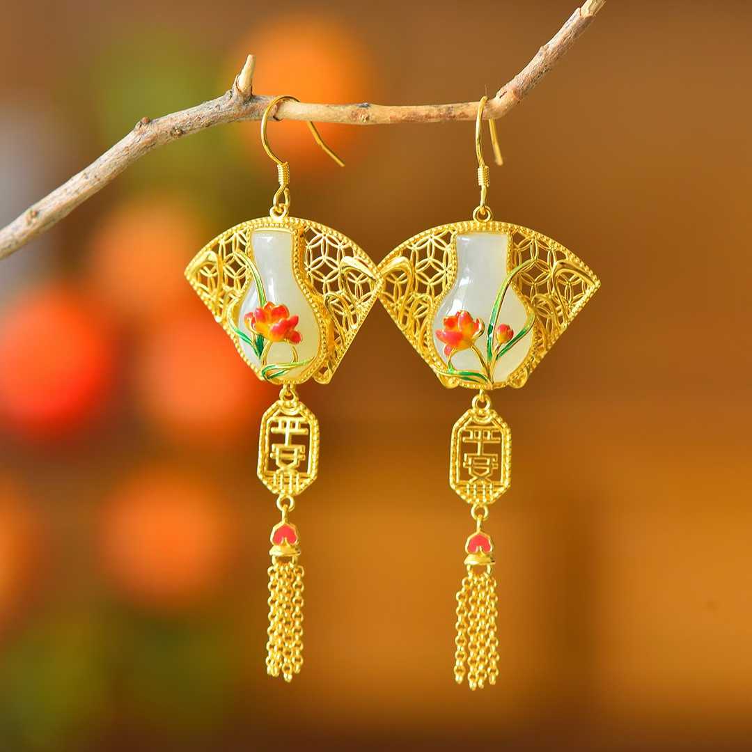 Detailed view of classic peace vase motif with long silver tassel on Hetian jade pendant