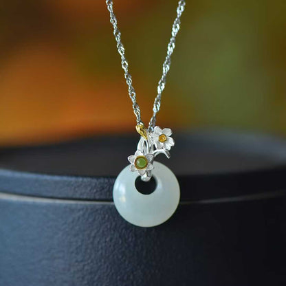 Detailed view of December daffodil motif on traditional Hetian nephrite jewelry"