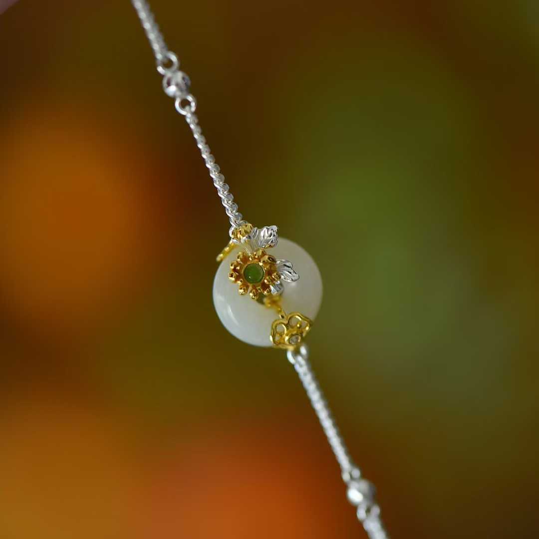 Detailed view of September chrysanthemum motif on traditional Hetian nephrite jewelry"