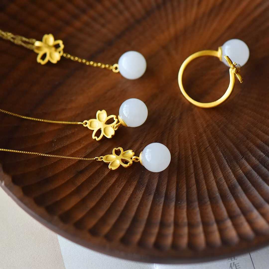 Premium nephrite cherry blossom jewelry with rich gilt luster and classic charm