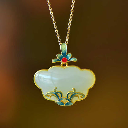 Close-up of orchid and grass design Hetian jade Ruyi lock pendant in sterling silver