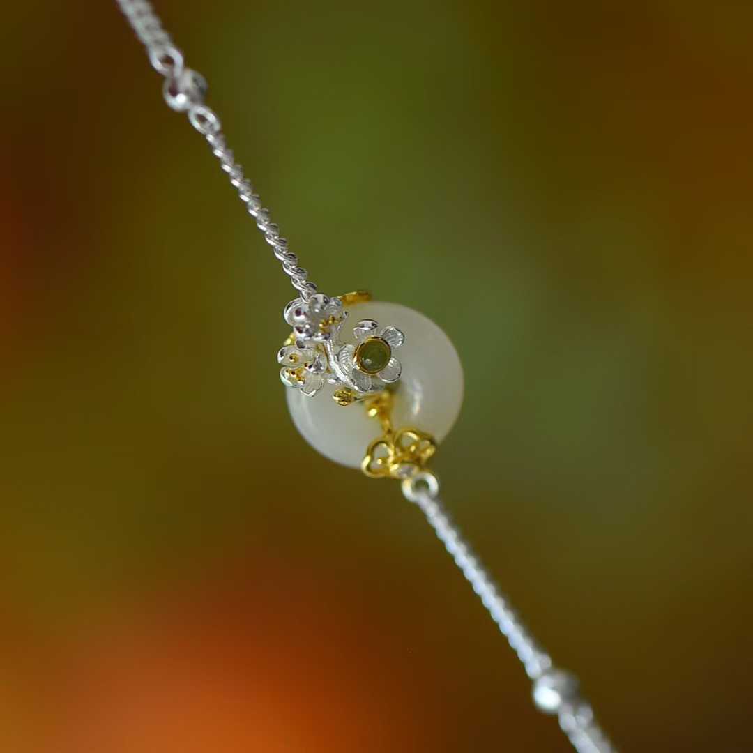 Detailed view of January plum blossom motif on traditional Hetian nephrite jewelry