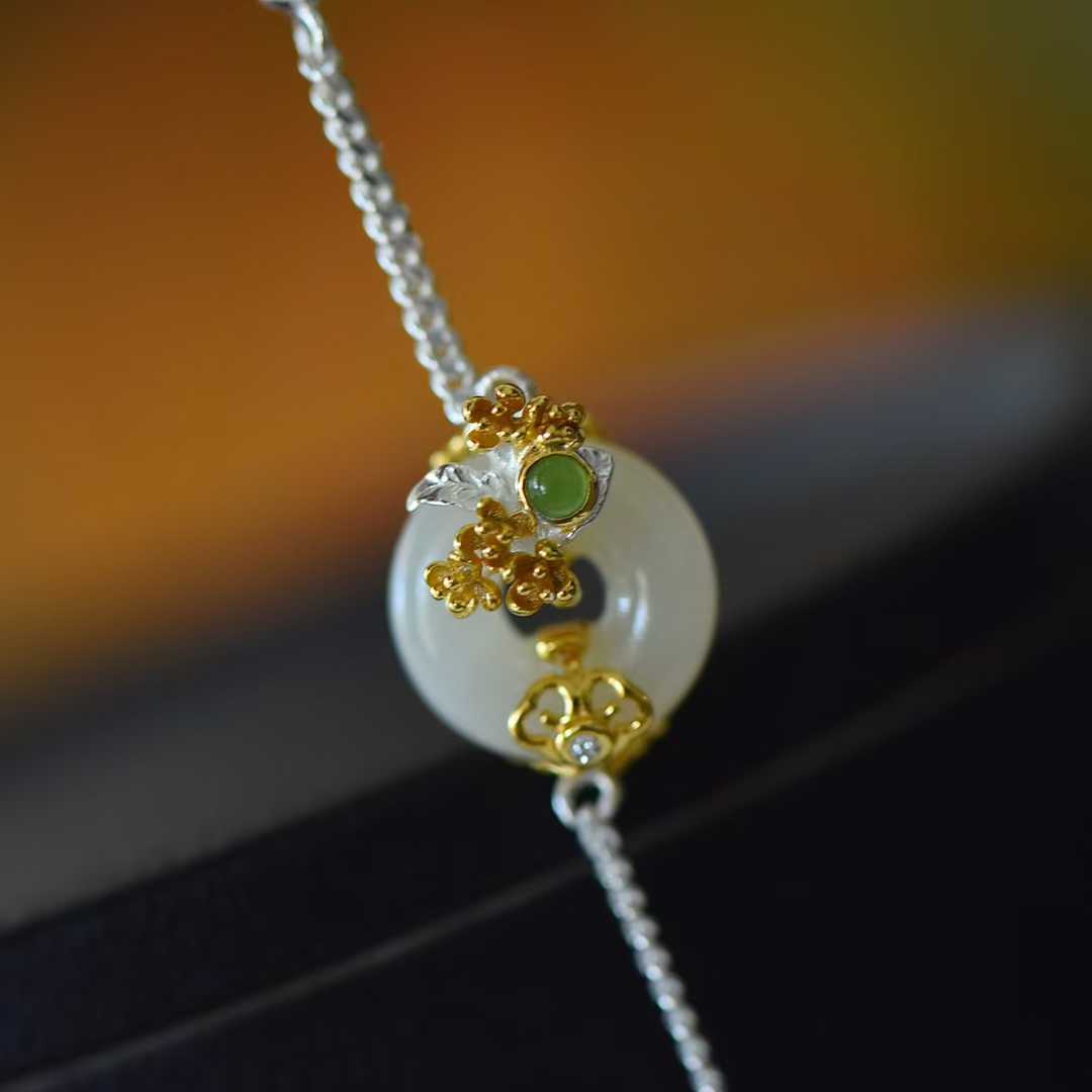 Close-up of osmanthus flower design Hetian jade pendant from Twelve Flower Gods series"