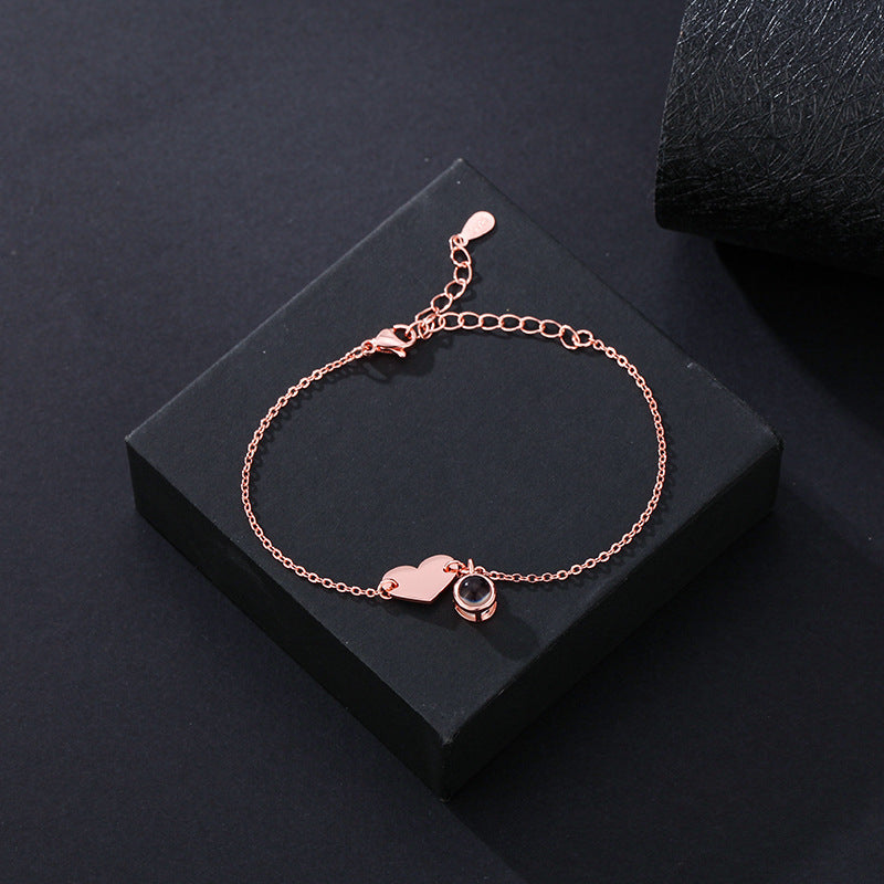 Heart-shaped engraved language projection bracelet