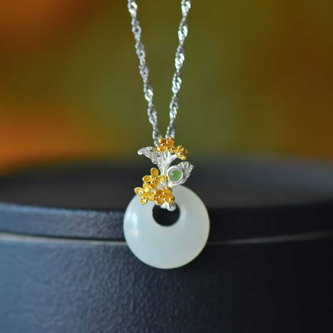 Detailed view of August osmanthus motif on traditional Hetian nephrite jewelry