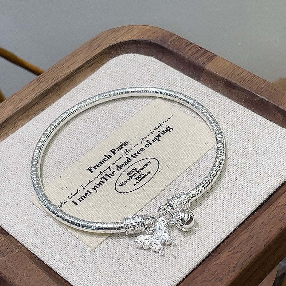 China round stick hanging bell butterfly sterling silver bracelet