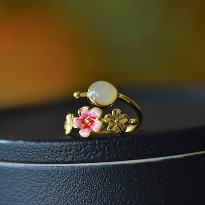  Elegant peach flowers motif detail on minimalist Hetian jade and silver jewelry

